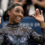 Simone Biles, of United States, celebrates after competing on the uneven bars during a women’s artistic gymnastics qualification round at Bercy Arena at the 2024 Summer Olympics