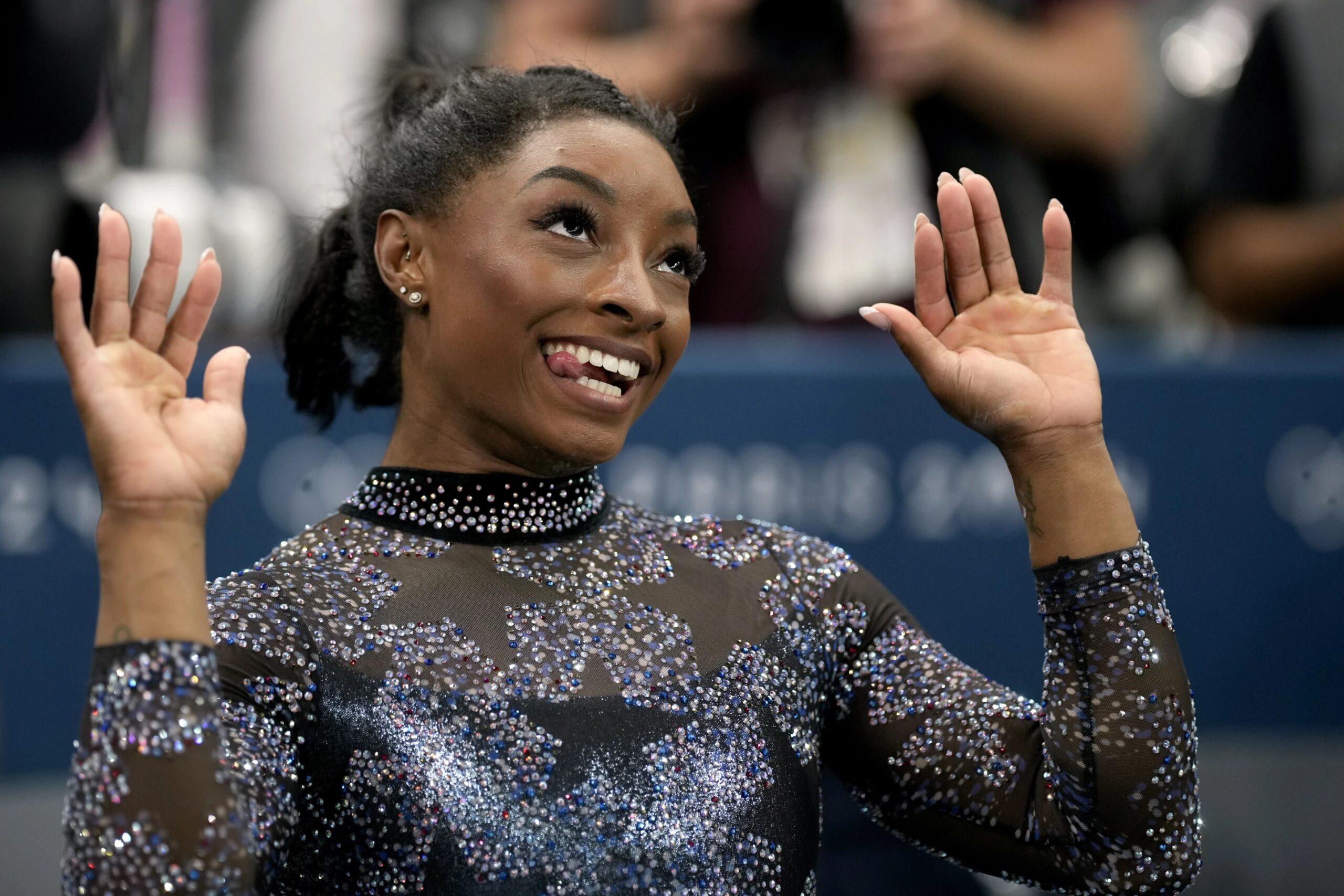 Simone Biles, of United States, celebrates after competing on the uneven bars during a women’s artistic gymnastics qualification round at Bercy Arena at the 2024 Summer Olympics