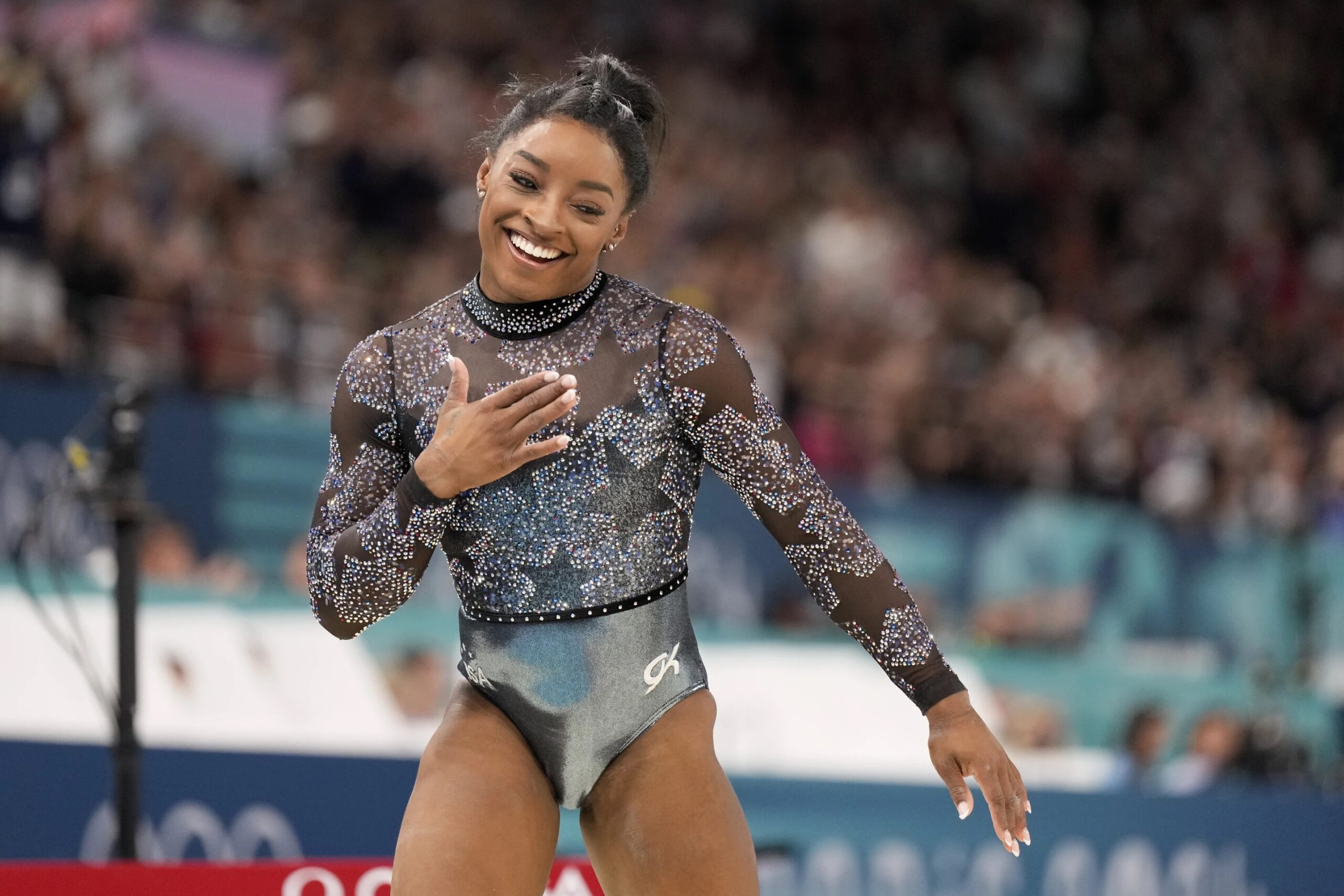 Simone Biles competes on the balance beam during a women’s artistic gymnastics qualification round at the 2024 Summer Olympics at Bercy Arena