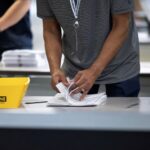 An election worker processes ballots at Philadelphia's vote counting facility on Pennsylvania's primary election day in Philadelphia, Pennsylvania, U.S. April 23, 2024.