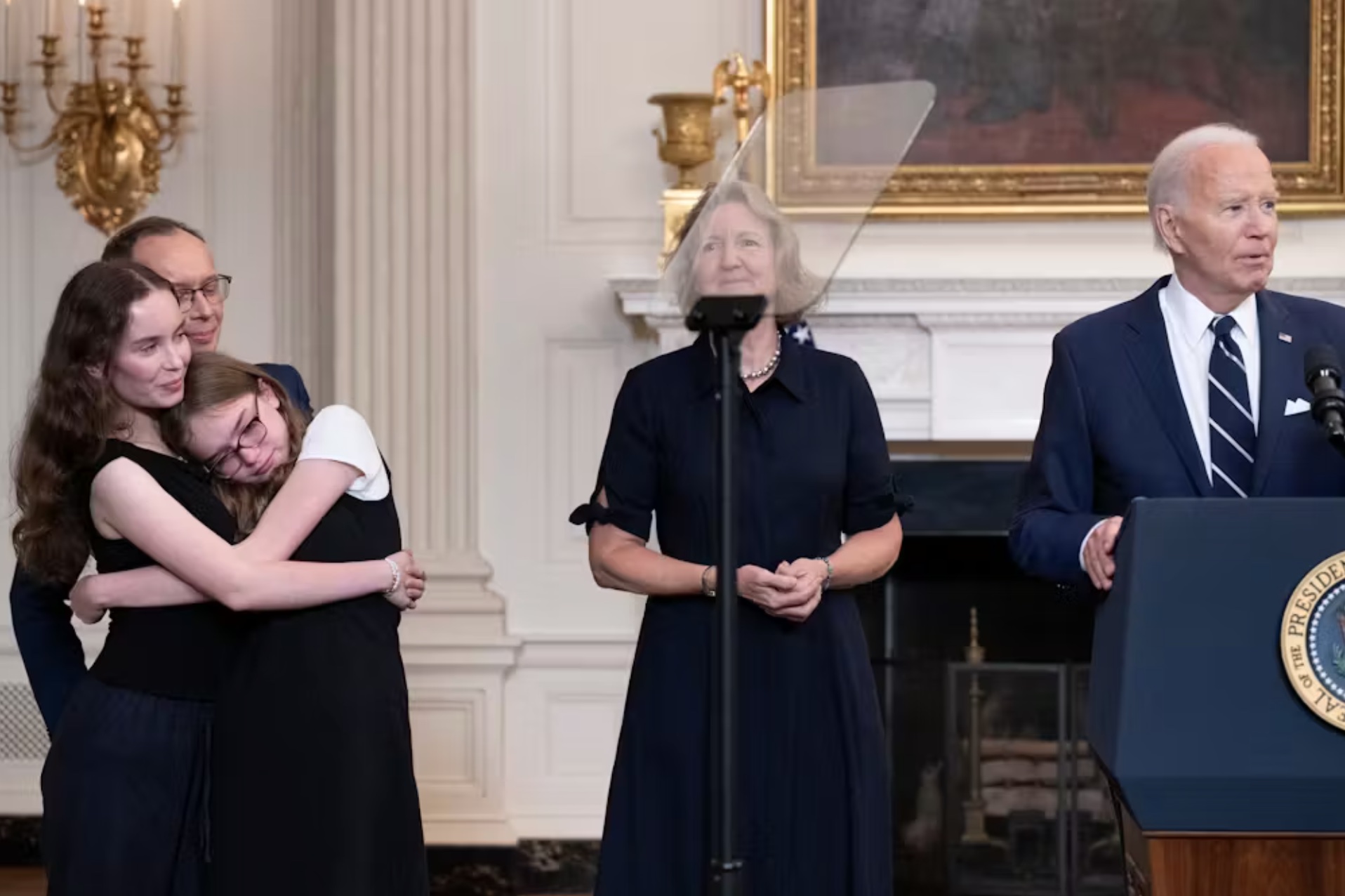 Family members of the Russian-American journalist Alsu Kurmasheva, who was released during the prisoner exchange on Aug. 1, 2024, stand with President Joe Biden at the White House as he speaks about the agreement. 