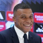 Kylian Mbappe, of France, smiles during a news conference after being presented to fans as a new Real Madrid player at the Santiago Bernabeu stadium in Madrid, Tuesday, July 16, 2024.