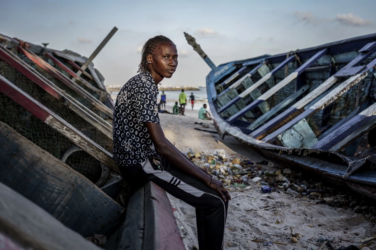 Salamba Ndiaye, a 28-year-old who tried to migrate to Europe twice, poses for a photo at the beach in Thiaroye-Sur-Mer, Senegal