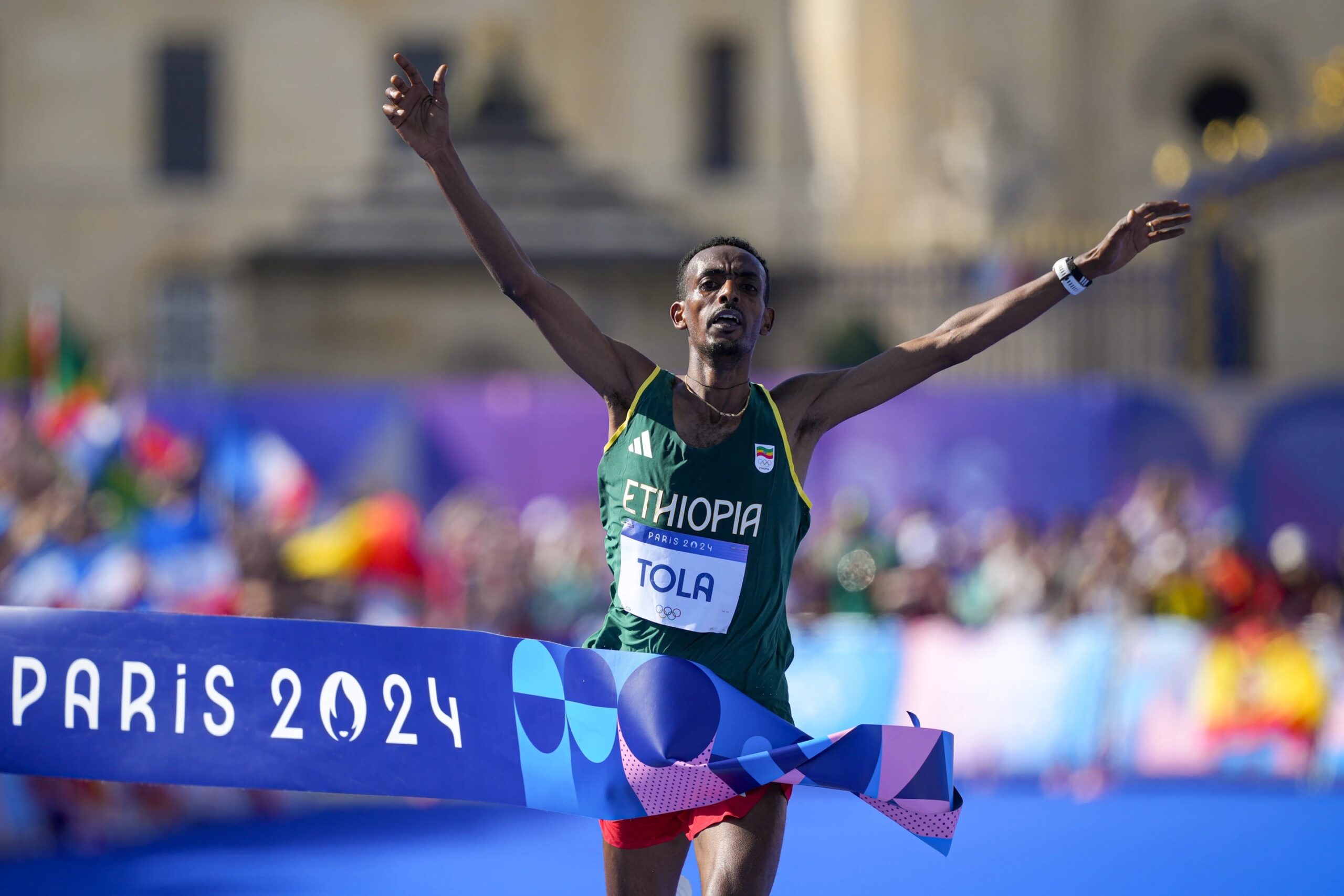 Ethiopia’s Tamirat Tola celebrates after crossing the finish line to win the gold medal at the end of the men’s marathon competition at the 2024 Summer Olympics, Saturday, Aug. 10, 2024, in Paris