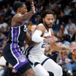 Dec 31, 2023; Memphis, Tennessee, USA; Memphis Grizzlies guard Derrick Rose (23) drives to the basket as Sacramento Kings guard De'Aaron Fox (5) defends during the second half at FedExForum.