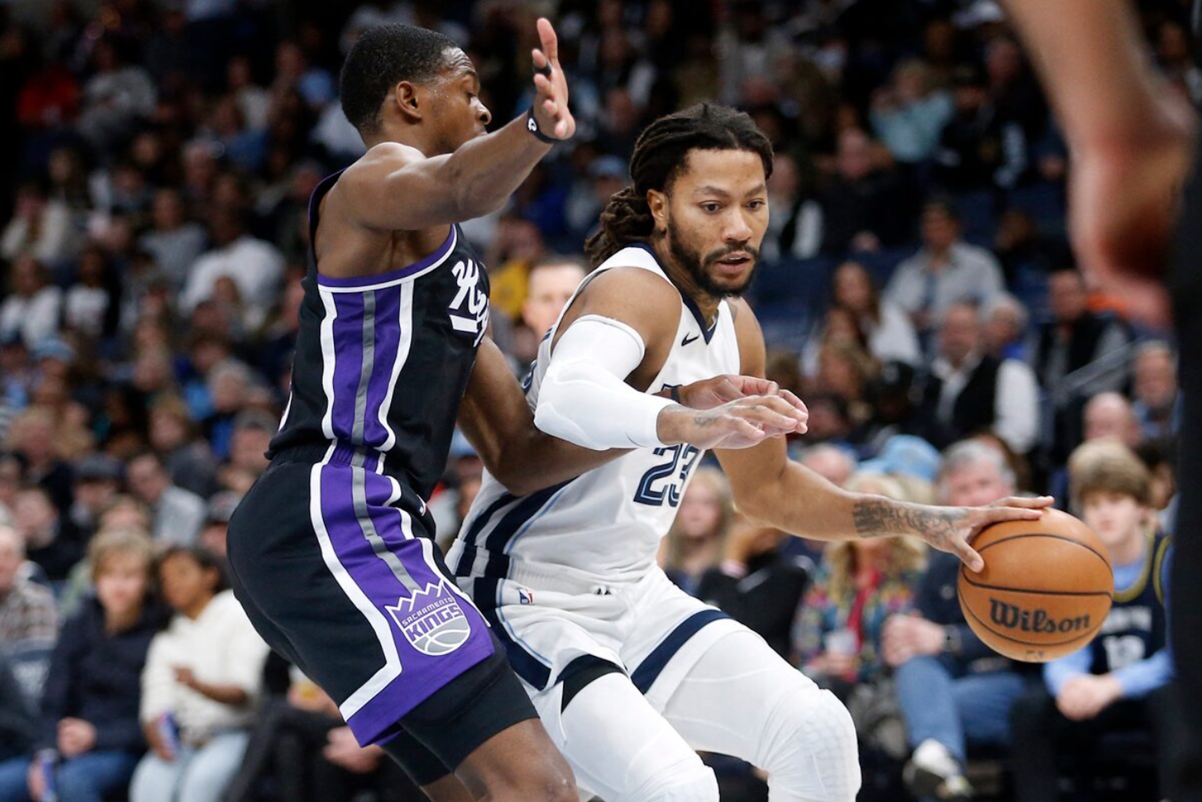 Dec 31, 2023; Memphis, Tennessee, USA; Memphis Grizzlies guard Derrick Rose (23) drives to the basket as Sacramento Kings guard De'Aaron Fox (5) defends during the second half at FedExForum. 