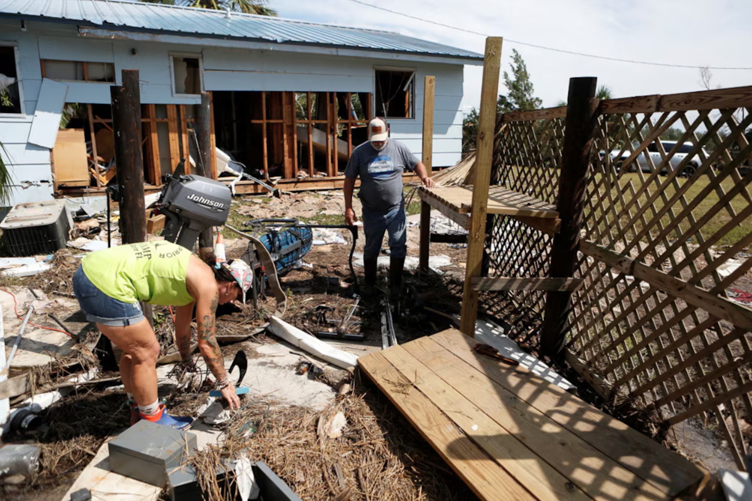 Leslie Merian and her husband David Hall survey the damage to their home and hotel after Hurricane Helene passed through the Florida panhandle, in Spring Warrior Fish Camp, Florida, U.S., September 28, 2024. 