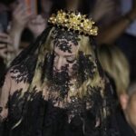 Madonna stands at the end of the Dolce & Gabbana Spring Summer 2025 fashion show, that was presented in Milan, Italy, Saturday, Sept. 21, 2024.