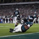 Philadelphia Eagles running back Saquon Barkley (26) catches a pass in front of Atlanta Falcons safety Jessie Bates III (3) during the second half of an NFL football game Monday, Sept. 16, 2024, in Philadelphia.