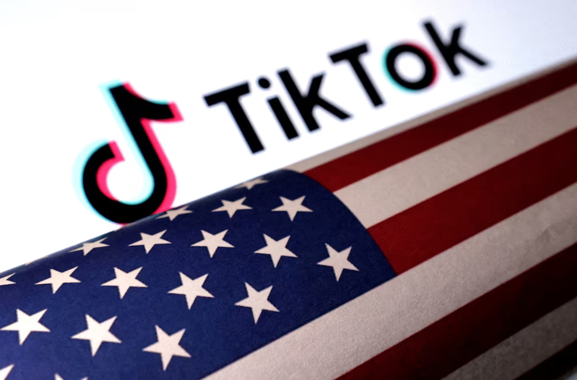 U.S. flag is placed on a TikTok logo in this illustration taken March 20, 2024. 