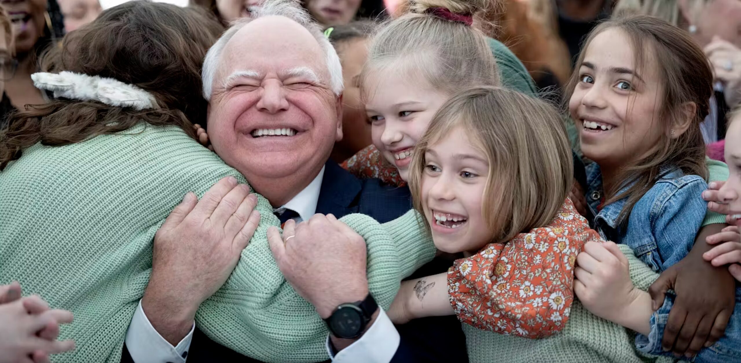 Minnesota Gov. Tim Walz gets hugs from students after signing into law a measure that guarantees free school meals at all of the state’s public and charter schools. 