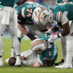 Miami Dolphins quarterback Tua Tagovailoa (1) lies on the field after suffering a concussion during the second half of an NFL football game against the Buffalo Bills, Thursday, Sept. 12, 2024, in Miami Gardens, Fla.