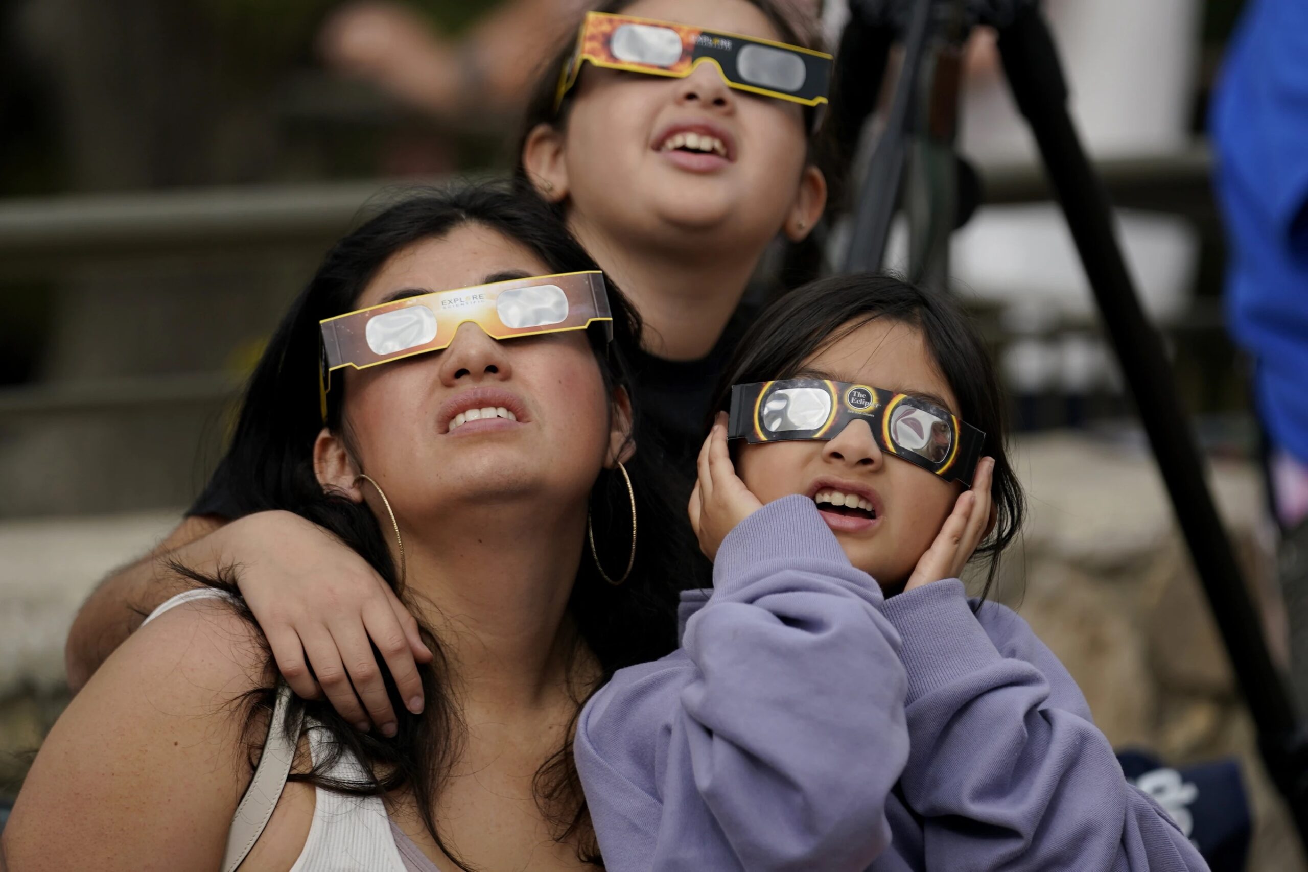 Viewers use special glasses to watch as the moon moves in front of the sun during an annular solar eclipse, or ring of fire, Saturday, Oct. 14, 2023, as seen from San Antonio.