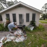 Will Marx cleans up remodeling debris in advance of Tropical Storm Helene, expected to become a hurricane before landfall, in Panacea, Fla., Wednesday, Sept. 25, 2024.