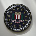 An FBI seal is seen on a wall on Aug. 10, 2022, in Omaha, Neb. Violent crime in the US dropped again in 2023, according to FBI statistics that show a continued trend downward after a coronavirus pandemic-era crime spike. The report released Monday shows overall violent crime ticked down an estimated 3% in 2023 from the year before, according to the FBI.