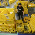 An employee scans incoming items at a receiving station at the Amazon OXR1 fulfillment center in Oxnard, Calif., on Aug. 21, 2024.