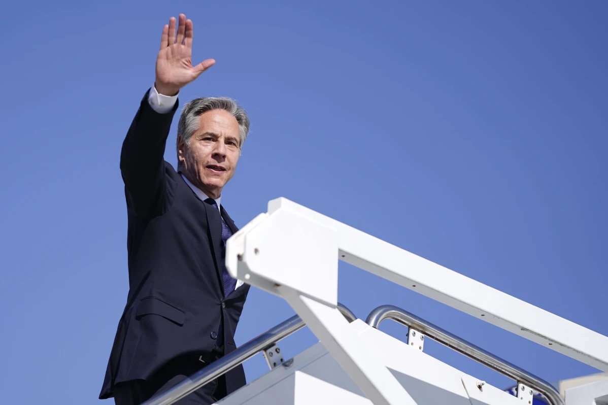 Secretary of State Antony Blinken waves as he boards a plane en route to the Middle East as he departs Joint Base Andrews, Md., Monday, Oct. 21, 2024.