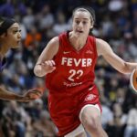 Indiana Fever guard Caitlin Clark (22) drives to the basket as Connecticut Sun guard DiJonai Carrington defends during a first-round WNBA basketball playoff game, Wednesday, Sept. 25, 2024, in Uncasville, Conn.