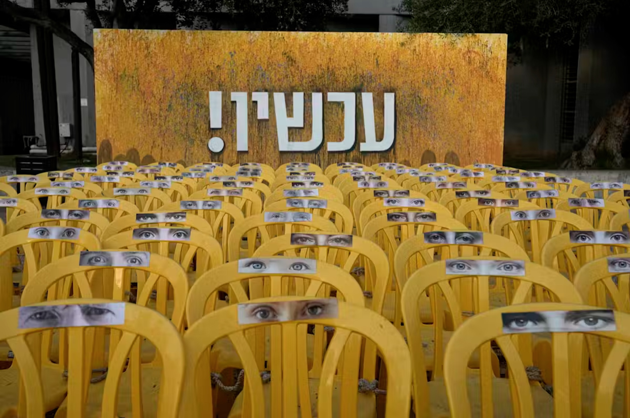 Chairs representing hostages held by Hamas militants in the Gaza Strip, displayed beneath the Hebrew word ‘Now!’ in Tel Aviv. 