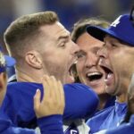 Los Angeles Dodgers’ Freddie Freeman, left, celebrates with starting pitcher Jack Flaherty, right, and teammates after hitting a walk-off grand slam against the New York Yankees during the 10th inning in Game 1 of the baseball World Series, Friday, Oct. 25, 2024, in Los Angeles. The Dodgers won 6-3.