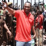 Freeman Mbowe waves at supporters outside a court in Tanzania during a past hearing.