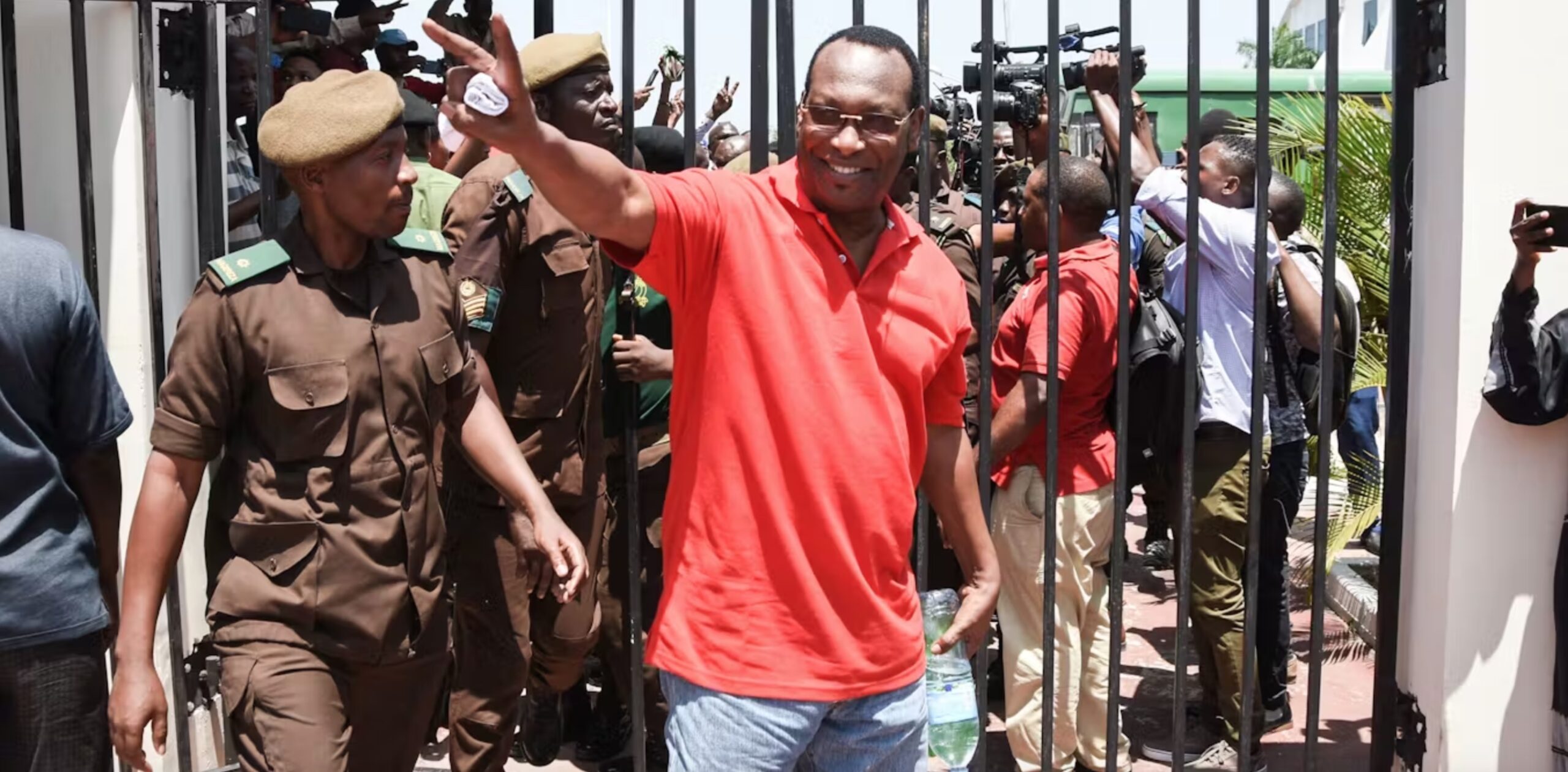 Freeman Mbowe waves at supporters outside a court in Tanzania during a past hearing. 