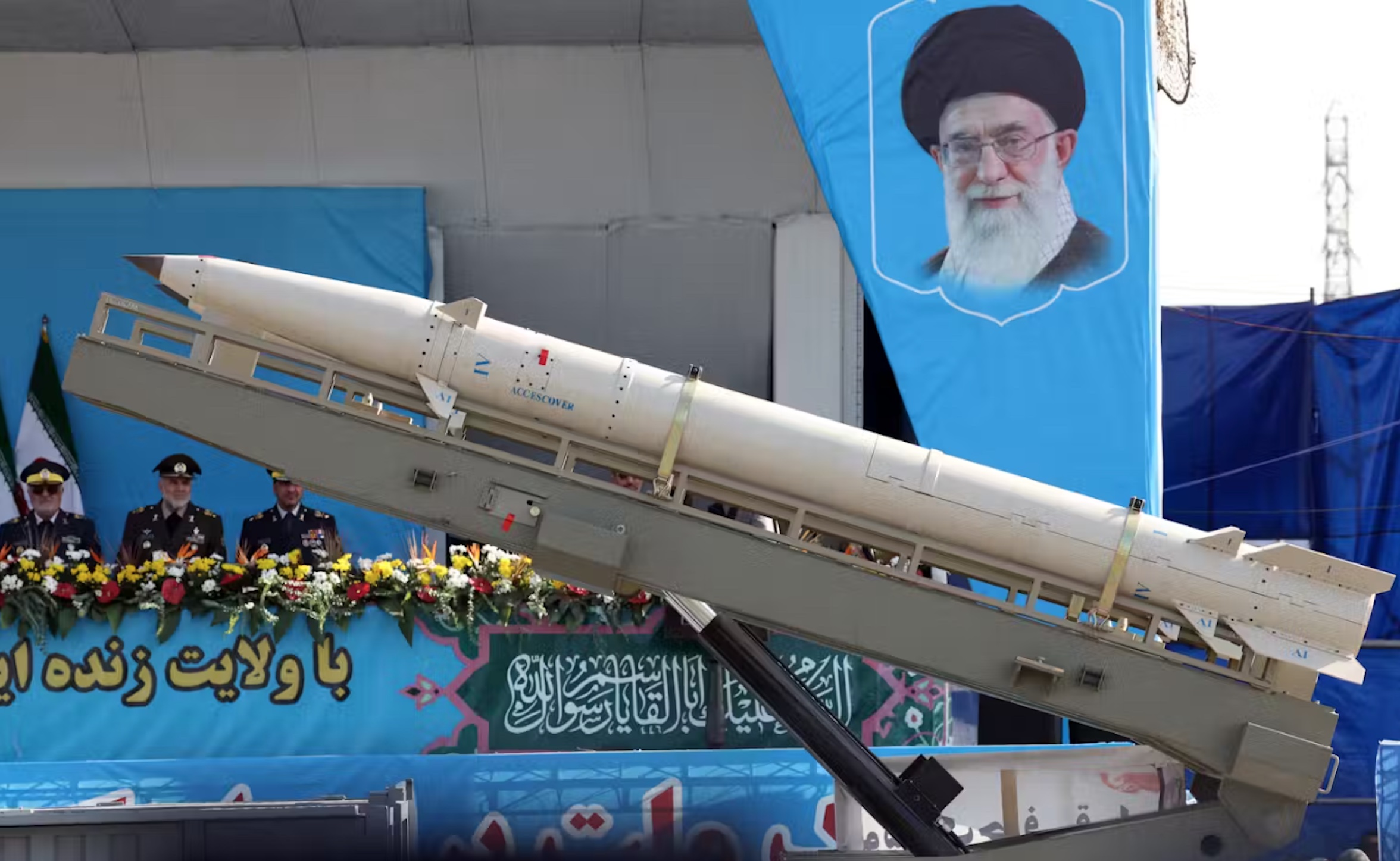 A truck carrying a missile passes by a picture of Iranian Supreme Leader Ayatollah Ali Khamenei during a military parade in Tehran. Abedin Taherkenareh/EPA