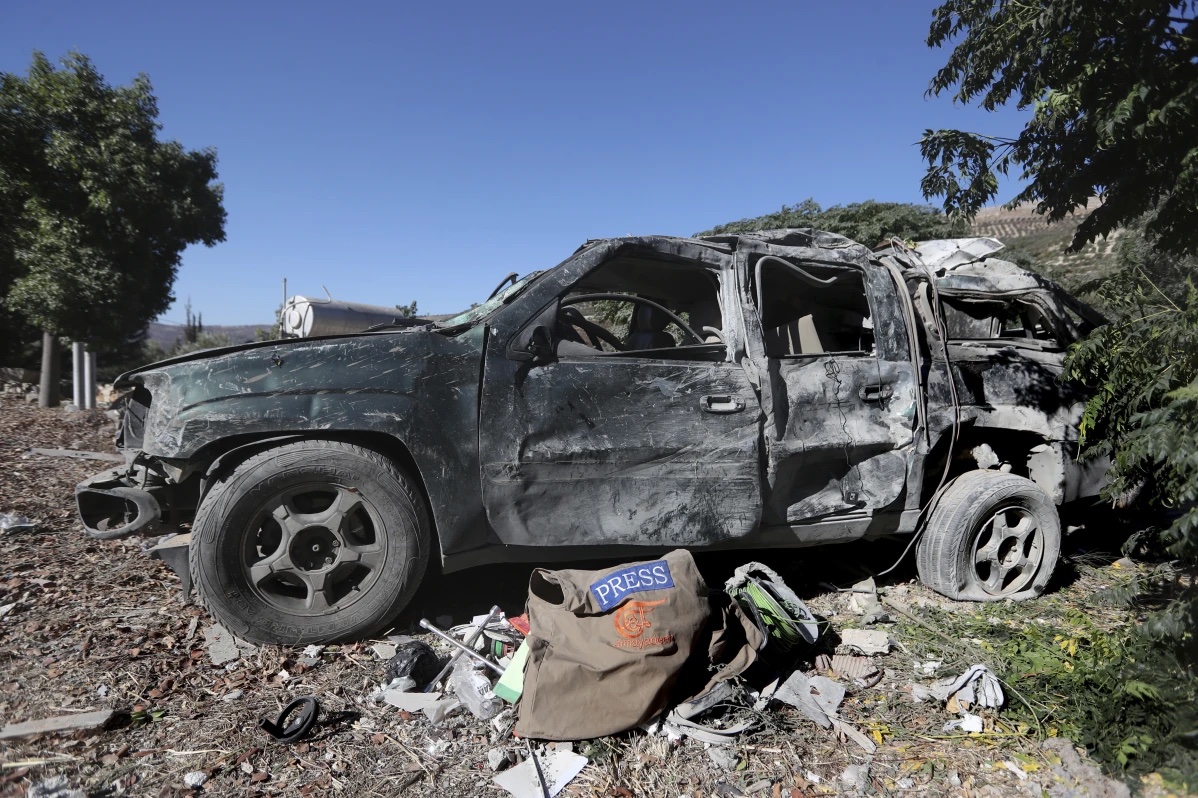 Journalists’ items on the ground next to a destroyed vehicle, at the site where an Israeli airstrike hit a compound housing journalists, killing three media staffers from two different news agencies according to Lebanon’s state-run National News Agency, in Hasbaya village, southeast Lebanon, Friday, Oct. 25, 2024.