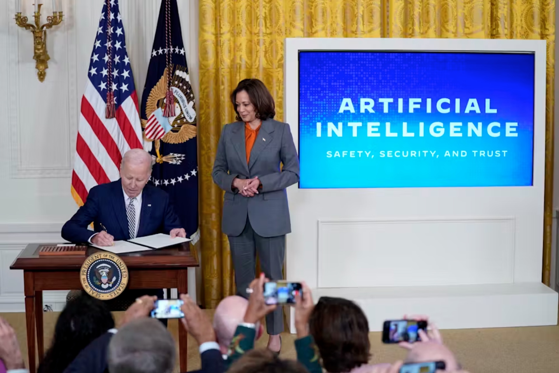 President Joe Biden signs an executive order addressing the risks of artificial intelligence on Oct. 30, 2023, with Vice President Kamala Harris at his side. 