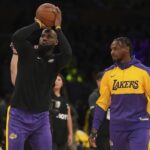 Los Angeles Lakers forward LeBron James, left, and guard Bronny James warm up before an NBA basketball game against the Minnesota Timberwolves, Tuesday, Oct. 22, 2024, in Los Angeles.