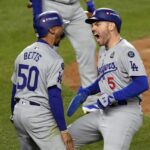 Los Angeles Dodgers’ Mookie Betts (50) and Freddie Freeman (5) celebrate after scoring against the New York Yankees during the fifth inning in Game 5 of the baseball World Series, Wednesday, Oct. 30, 2024, in New York.