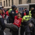 Police officers detain a demonstrator protesting Israel’s war against Hamas as they occupy an area outside the New York Stock Exchange, Monday, Oct. 14, 2024, in New York.