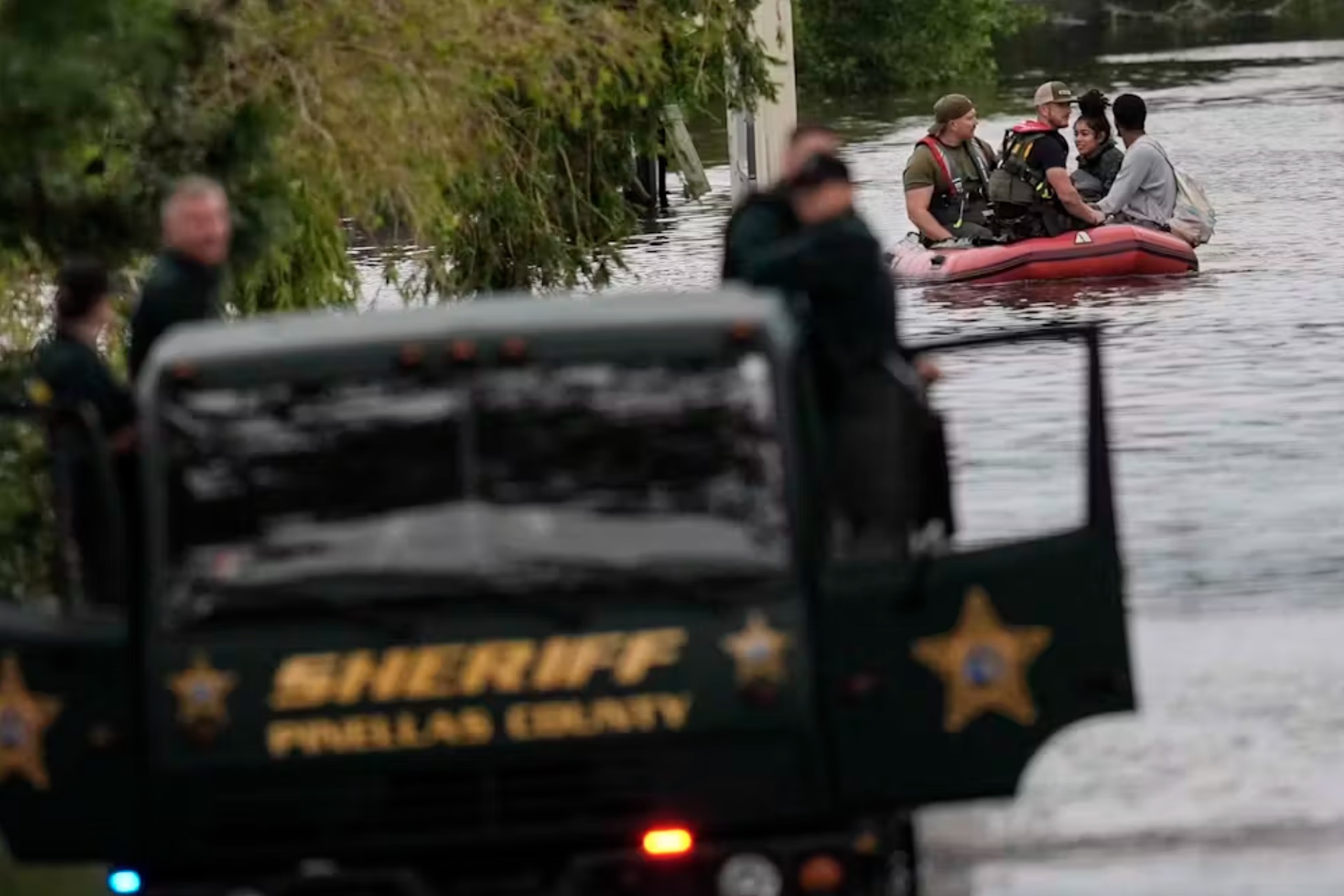 Rescuers help people get out of a flooded apartment complex in Clearwater, Fla., on Oct. 10, 2024, in the aftermath of Hurricane Milton. 