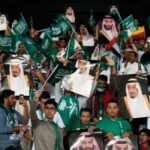 Saudi fans hold pictures of Saudi Arabia’s King Salman and Saudi Crown Prince Mohammed bin Salman ahead of the AFC Asian Cup group E soccer match between Saudi Arabia and Qatar in Abu Dhabi, United Arab Emirates, in January 2018.