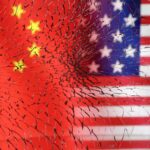 U.S. and Chinese flags are seen through broken glass in this illustration taken, January 30, 2023.