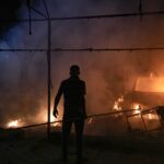 A Palestinian man reacts to a fire after an Israeli strike hit a tent area in the courtyard of Al Aqsa Martyrs hospital in Deir al Balah, Gaza Strip, Monday, Oct. 14, 2024.