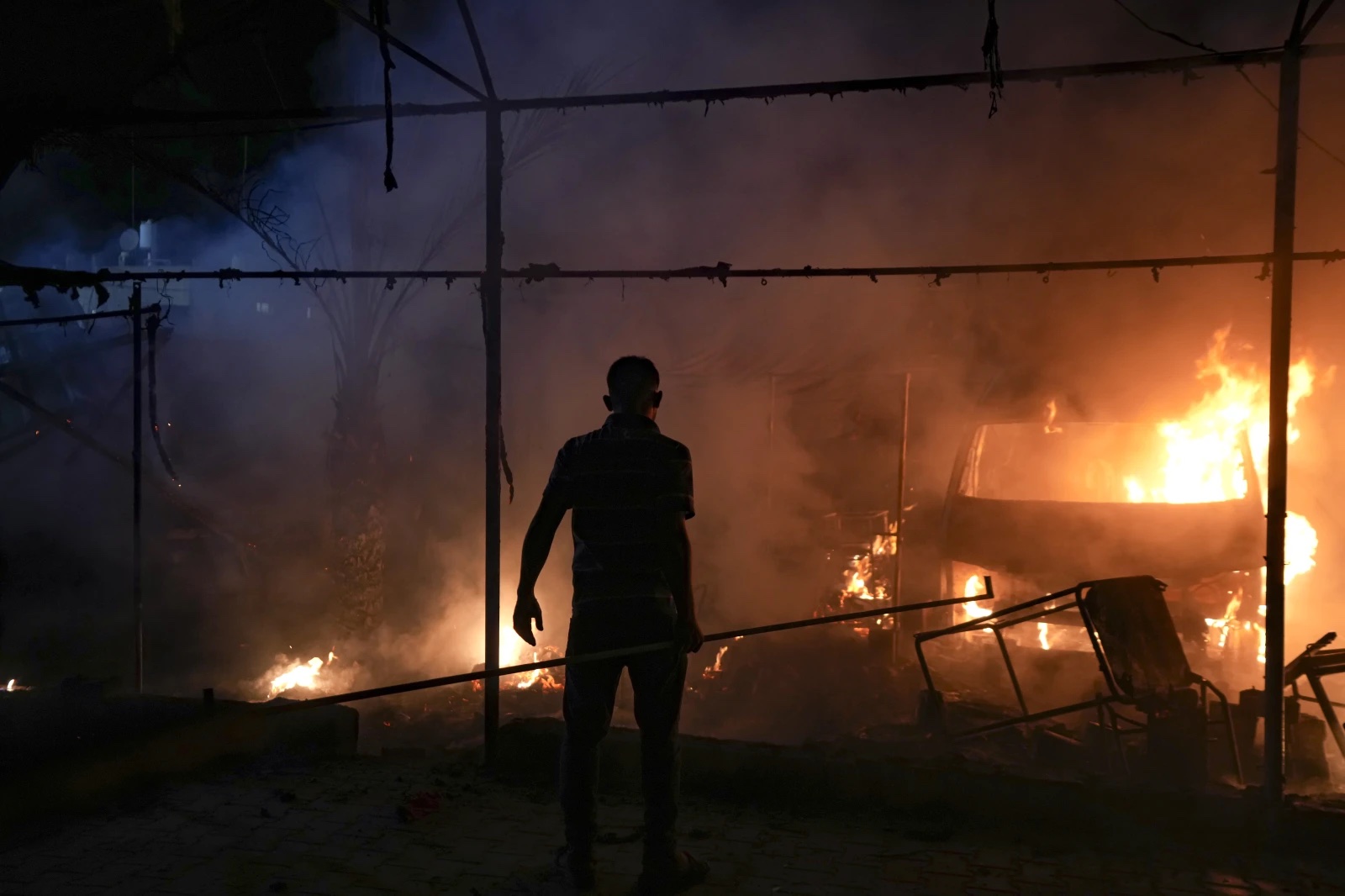 A Palestinian man reacts to a fire after an Israeli strike hit a tent area in the courtyard of Al Aqsa Martyrs hospital in Deir al Balah, Gaza Strip, Monday, Oct. 14, 2024.