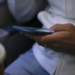 A woman looks at a hand held device on a train in New Jersey on May 18, 2021.