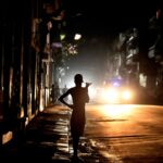 People stand in the street at night as Cuba is hit by an island-wide blackout, in Havana, Cuba, October 18, 2024.