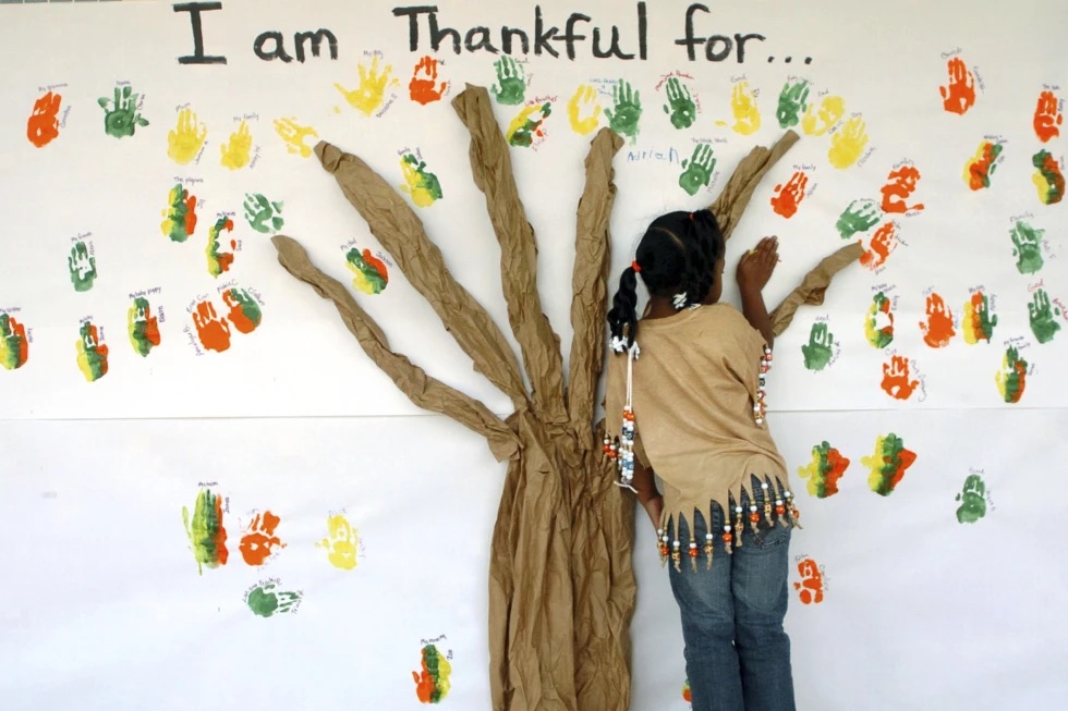 A student places her handprint along with those of other students at a primary school in Lufkin, Texas on Tuesday, Nov. 22, 2005. 