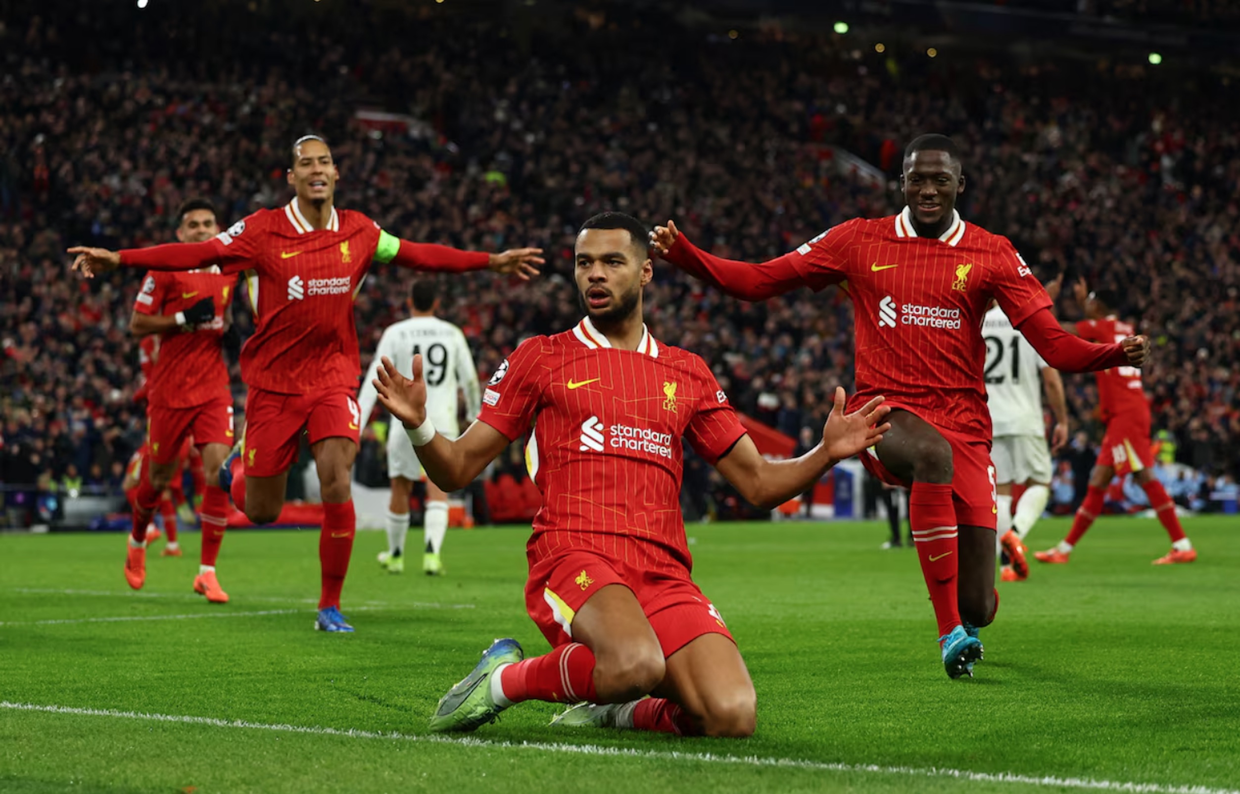 Soccer Football - Champions League - Liverpool v Real Madrid - Anfield, Liverpool, Britain - November 27, 2024 Liverpool's Cody Gakpo celebrates scoring their second goal with Virgil van Dijk and Ibrahima Konate 