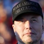 Tesla and SpaceX CEO Elon Musk listens as Republican presidential nominee former President Donald Trump speaks at a campaign event at the Butler Farm Show, Oct. 5, 2024, in Butler, Pa.