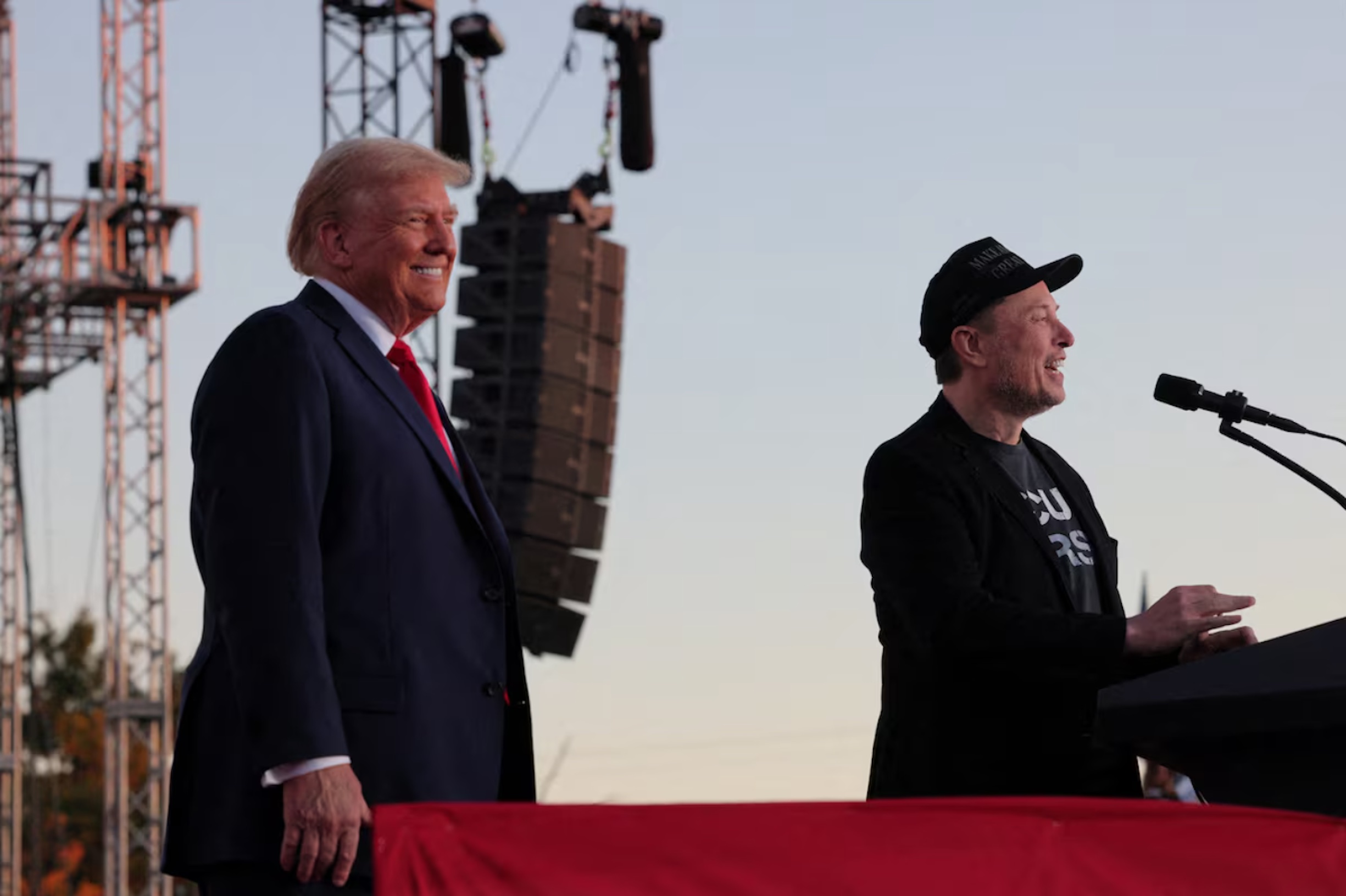 Tesla CEO and X owner Elon Musk speaks as Donald Trump looks on during a rally at the site of the July assassination attempt against Trump, in Butler, Pennsylvania, U.S., October 5, 2024. 