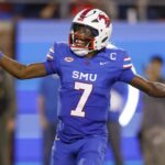 SMU quarterback Kevin Jennings (7) celebrates after throwing a touchdown pass during the first half of an NCAA college football game against Pittsburgh in Dallas, Saturday, Nov. 2, 2024.