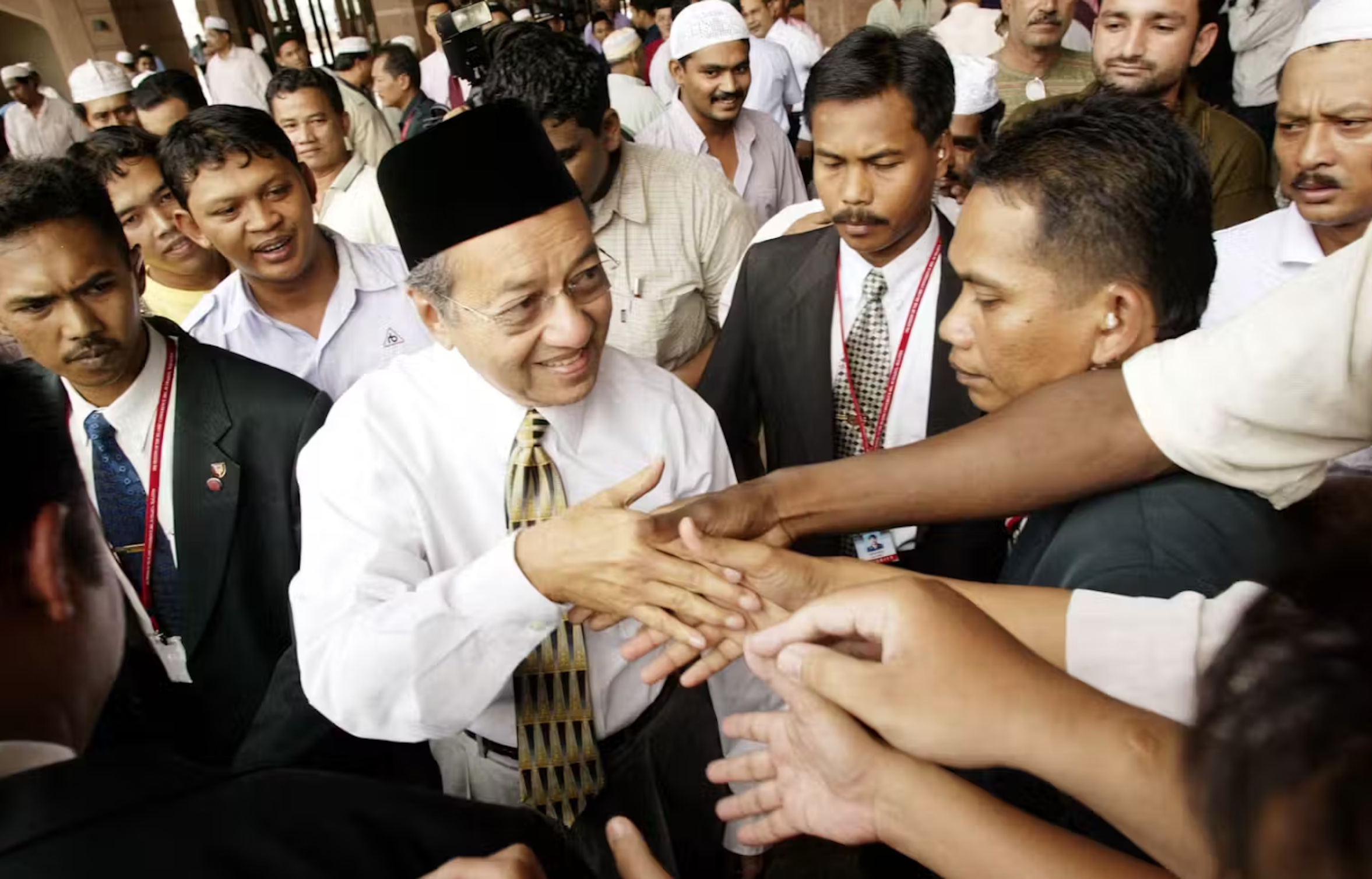 Malaysian Prime Minister Mahathir Mohamad greeting worshippers at a mosque in 2003. 