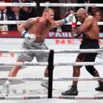 Nov 15, 2024; Arlington, Texas, UNITED STATES; Mike Tyson (black gloves) fights Jake Paul (silver gloves) at AT&T Stadium.