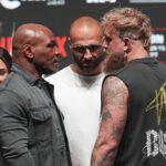 Mike Tyson, front left, and Jake Paul, front right, face off during a news conference ahead of their fight, Wednesday, Nov. 13, 2024, in Irving, Texas.