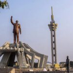 Workers stand by a memorial for Democratic Republic of the Congo independence hero Patrice Lumumba, in Kinshasa, Congo, June 20, 2022.