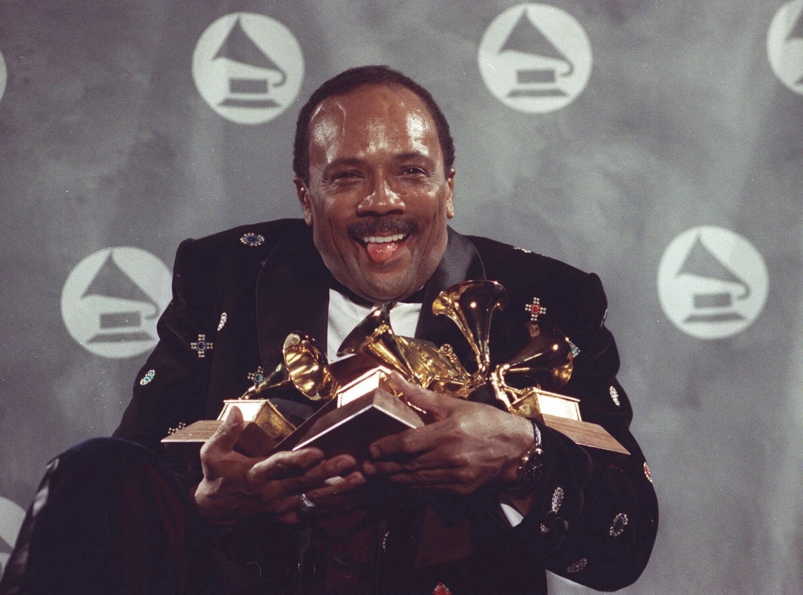 Quincy Jones cradles his Grammy awards including the album of the year award, for his eclectic album “Back on the Block” during the 33rd annual Grammy Awards, at New York’s Radio City Music Hall night of Feb.20,1991.