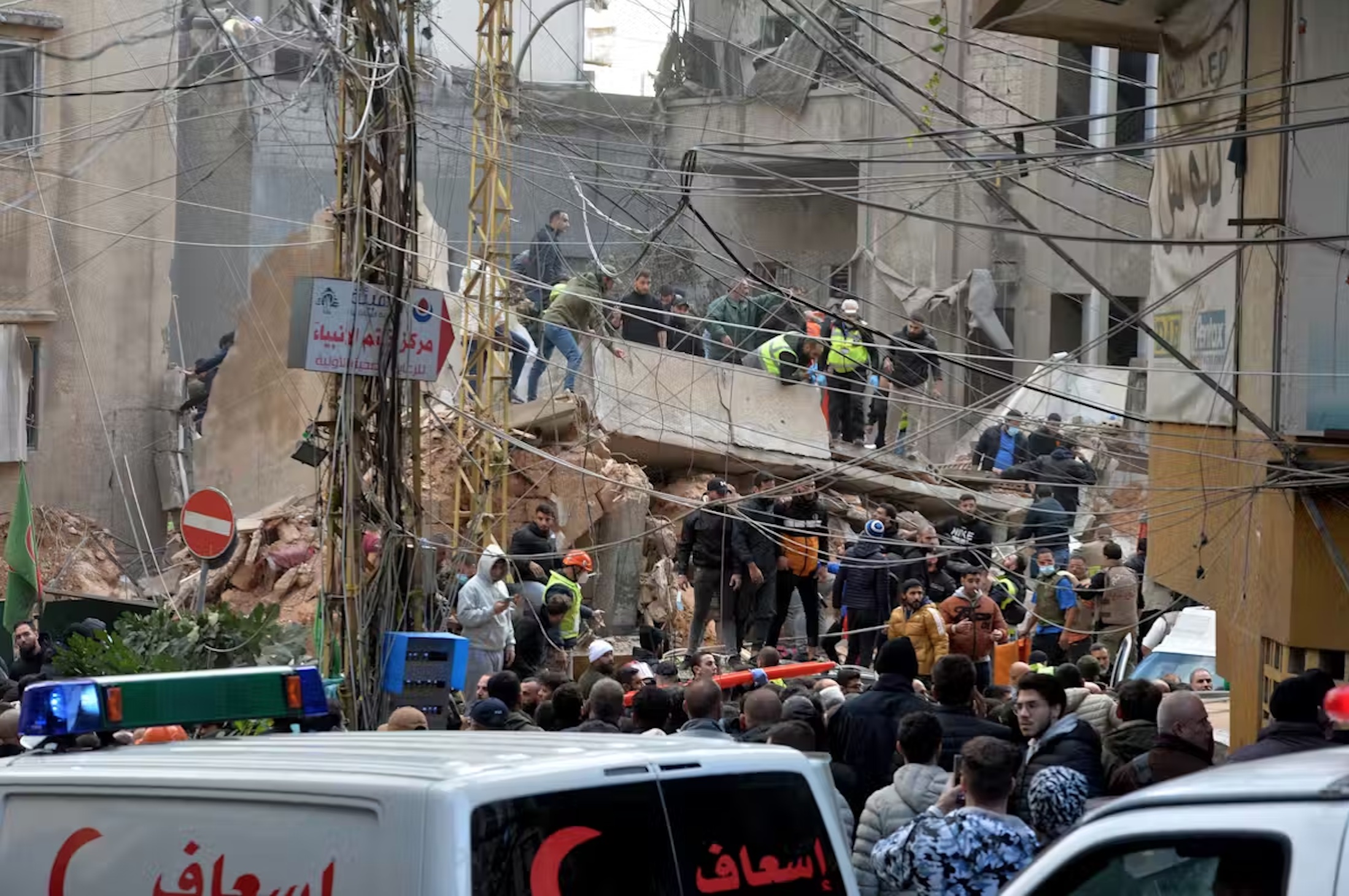 Rescuers search the rubble of a building following an Israeli airstrike on an area of Beirut. 